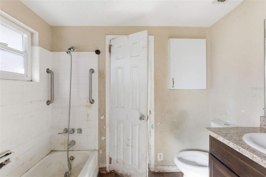 762 Valencia Avenue Orange City, FL 32763 - Photo 34 of 39 a bathroom with a granite countertop sink a toilet and shower