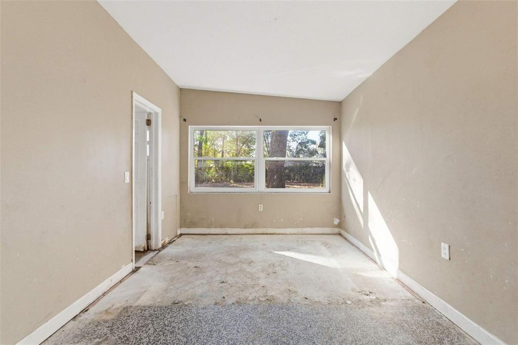 762 Valencia Avenue Orange City, FL 32763 - Photo 10 of 39 an empty room with large windows