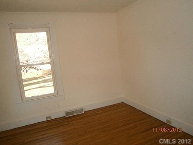 1501 South Ridge Avenue Kannapolis, NC 28083 - Photo 5 of 9 an empty room with wooden floor and windows