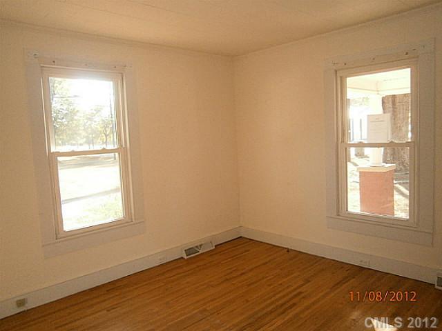 1501 South Ridge Avenue Kannapolis, NC 28083 - Photo 8 of 9 an empty room with wooden floor and windows