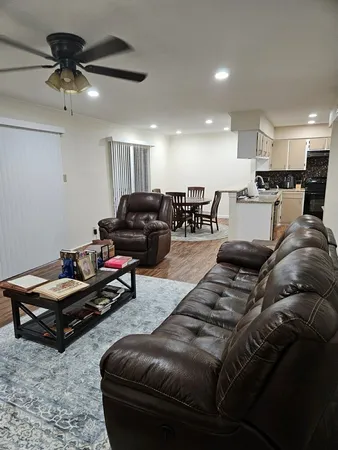 a living room with furniture and a wooden floor
