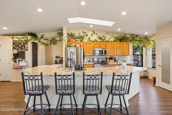 a kitchen with stainless steel appliances granite countertop a stove and a refrigerator