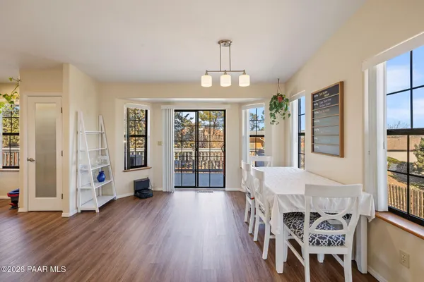 a view of a dining room with furniture window and wooden floor
