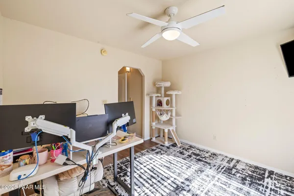 a spacious bedroom with a bed a dresser and a window