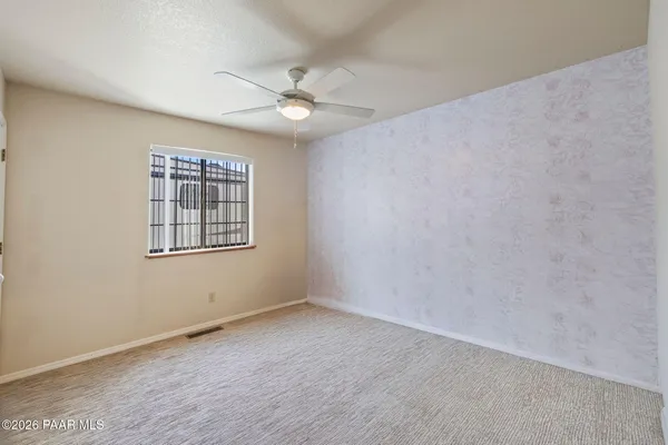 a view of a workspace with furniture and a window