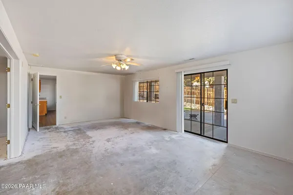 a view of a room with furniture and a large window