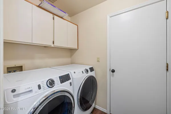 an empty room with a ceiling fan and a window