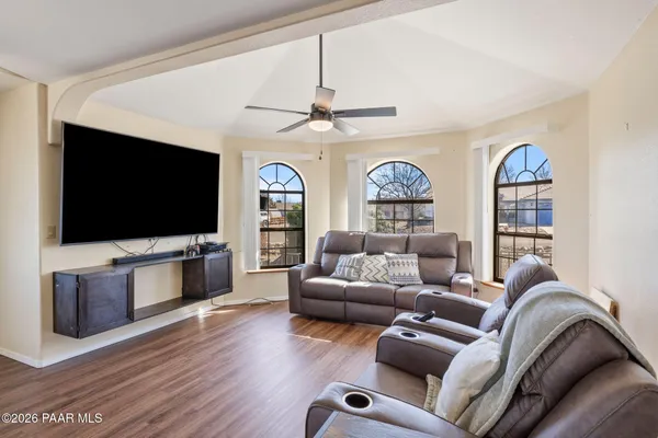 a living room with furniture and a wooden floor
