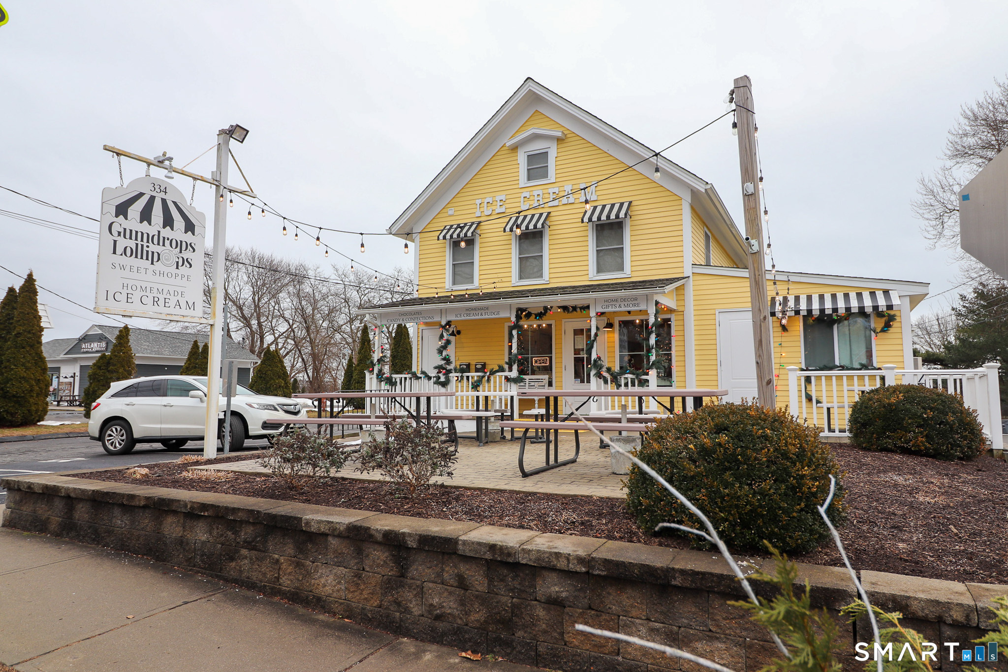 374 Main Street, Unit C Niantic, CT 06357 - Photo 27 of 31 a view of a white house with large windows and a table