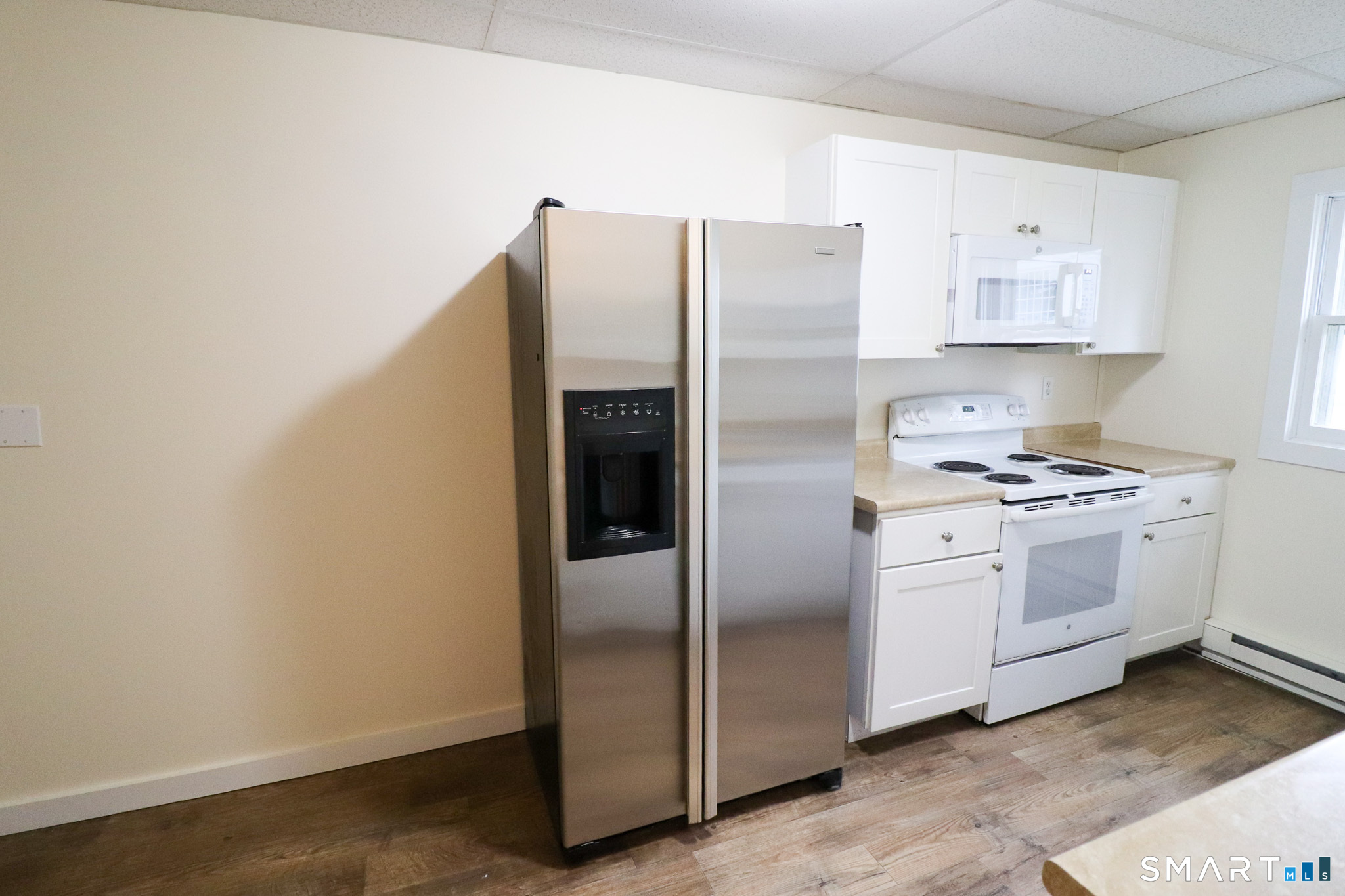 374 Main Street, Unit C Niantic, CT 06357 - Photo 5 of 31 a kitchen with cabinets stainless steel appliances and a refrigerator