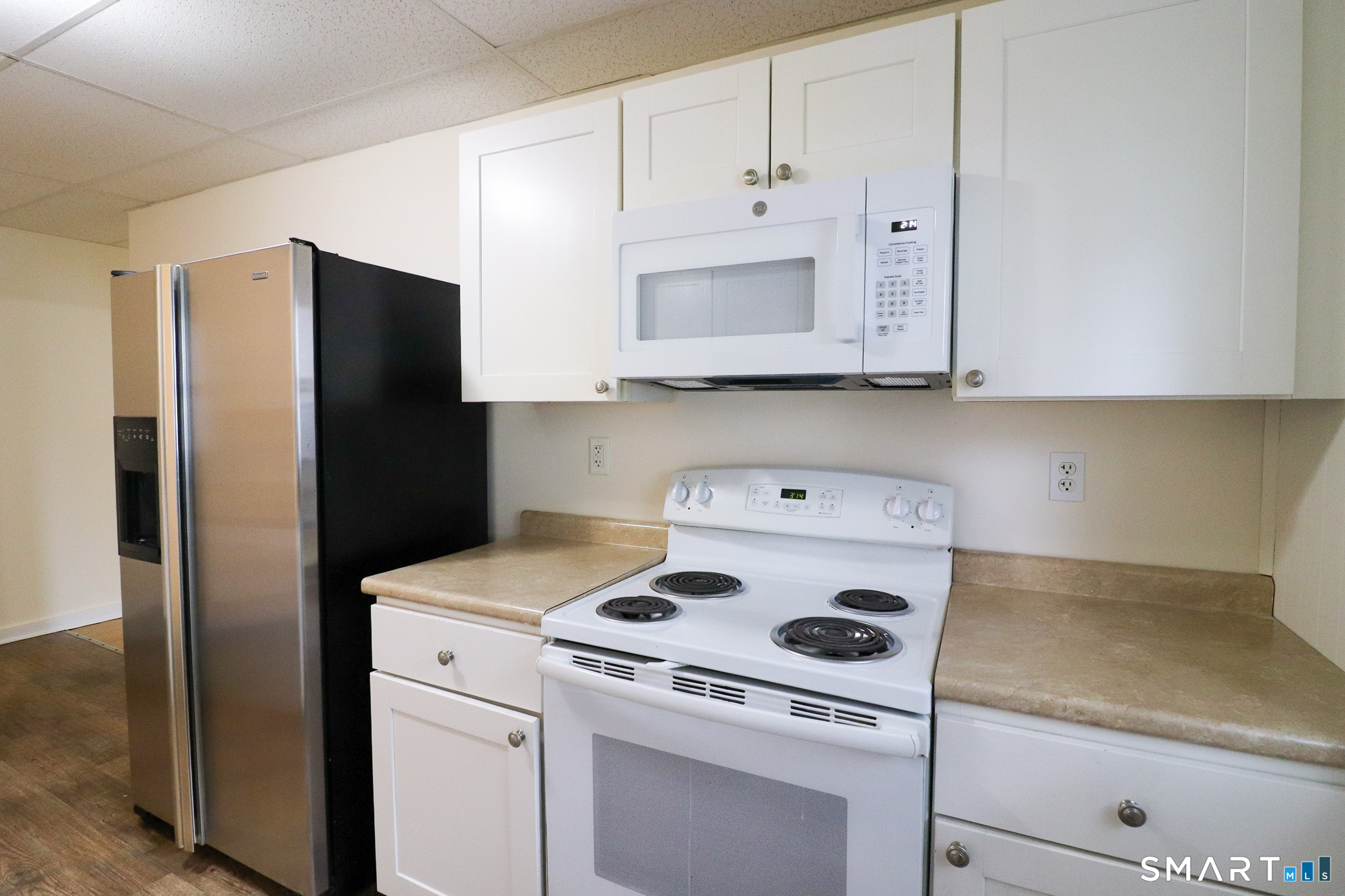 374 Main Street, Unit C Niantic, CT 06357 - Photo 8 of 31 a kitchen with a refrigerator stove and cabinets