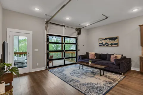 a living room with furniture and wooden floor