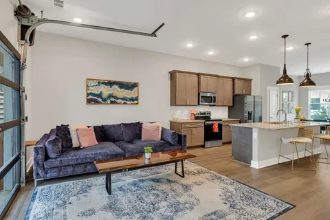 a living room with furniture and kitchen view