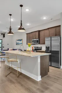 a kitchen with stainless steel appliances granite countertop a refrigerator sink and microwave