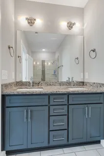 a bathroom with a granite countertop sink a mirror and a vanity
