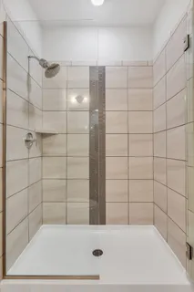 a bathroom with a bathtub and shower