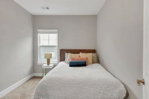 a bedroom with a large bed and a window