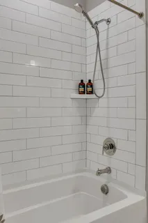 a bathroom with a bath tub and a shower