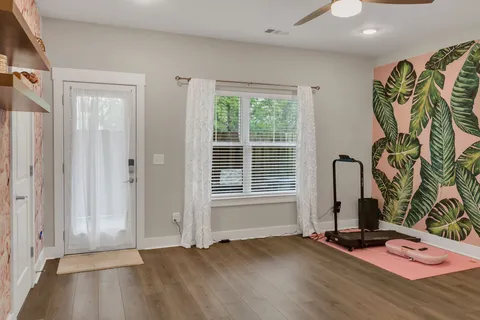 an empty room with window and glass door