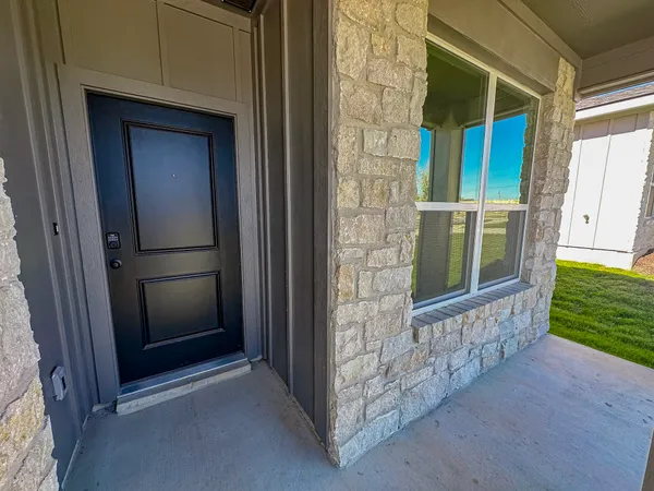 a view of porch with a door and chair