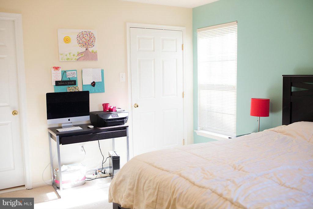3018 Hunting Ridge Drive, Unit 3018 Owings Mills, MD 21117 - Photo 13 of 30 a bedroom with a bed and a computer on a desk
