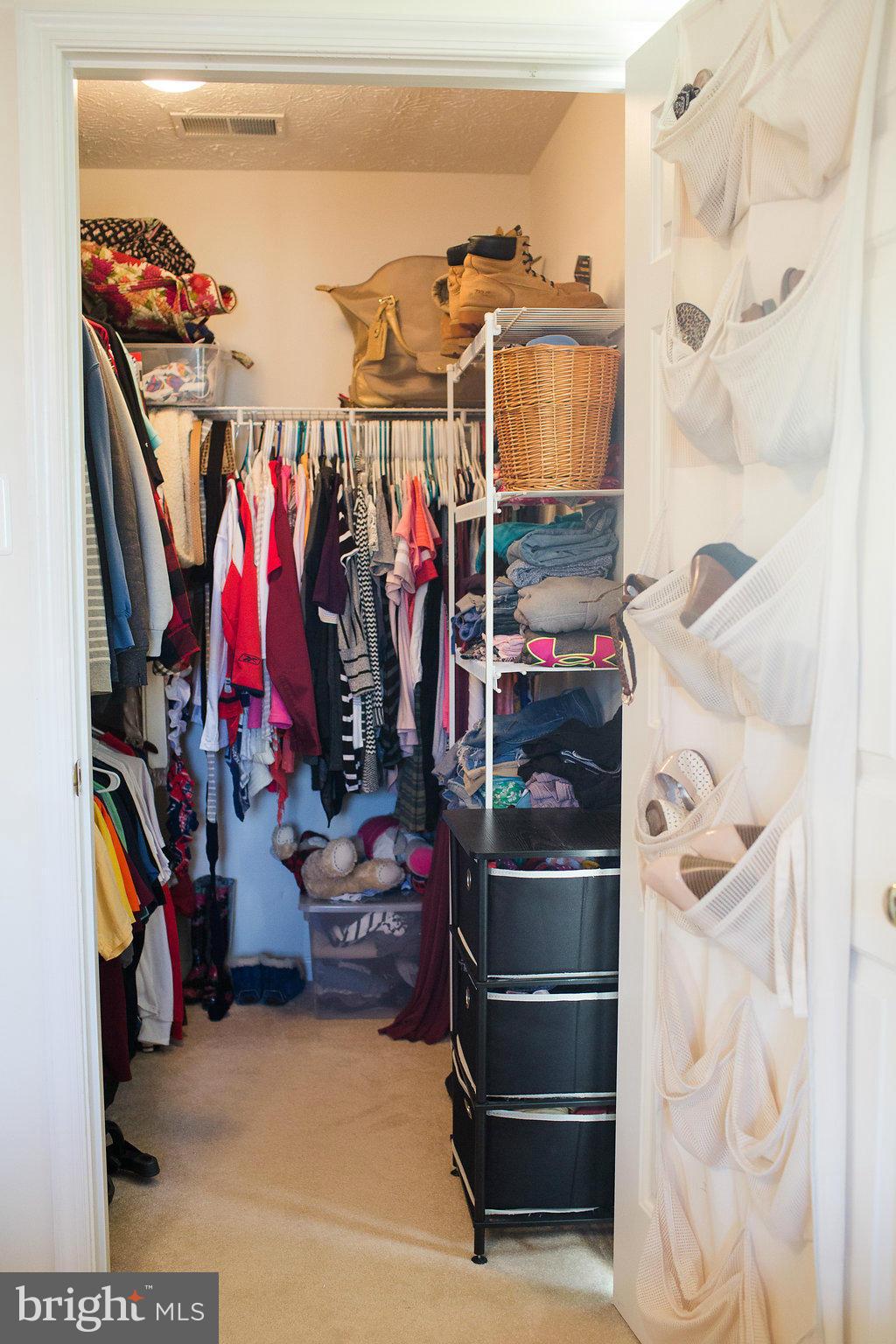 3018 Hunting Ridge Drive, Unit 3018 Owings Mills, MD 21117 - Photo 14 of 30 a view of walk in closet with clothes and shoes