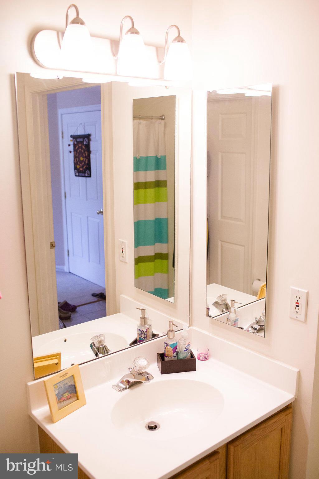 3018 Hunting Ridge Drive, Unit 3018 Owings Mills, MD 21117 - Photo 22 of 30 a bathroom with a sink and a mirror