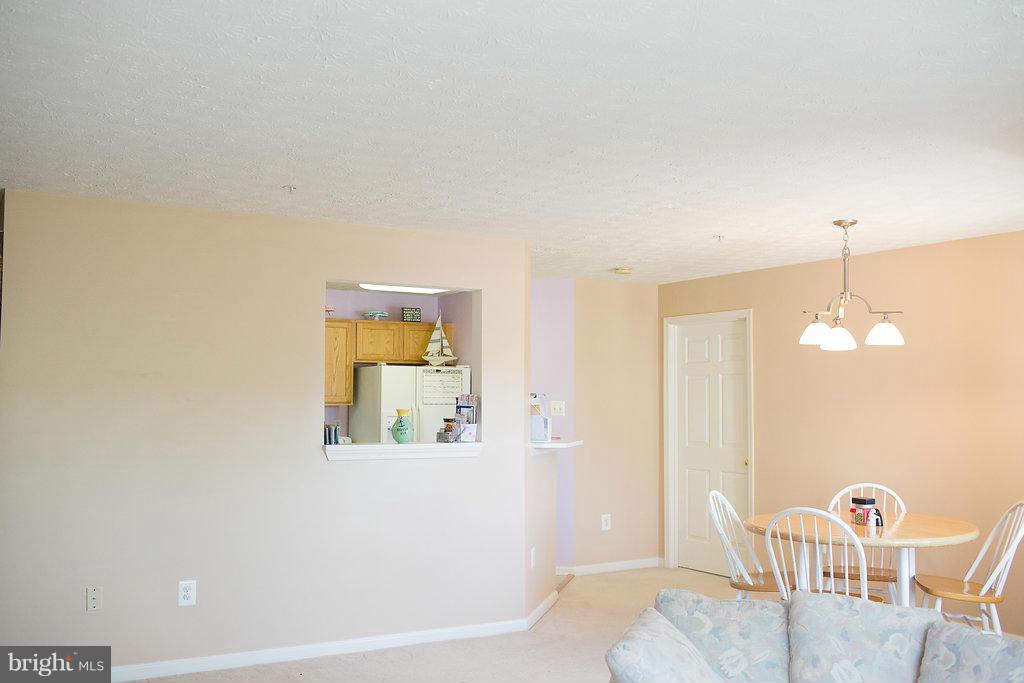 3018 Hunting Ridge Drive, Unit 3018 Owings Mills, MD 21117 - Photo 7 of 30 a view of a dining room with furniture and a chandelier