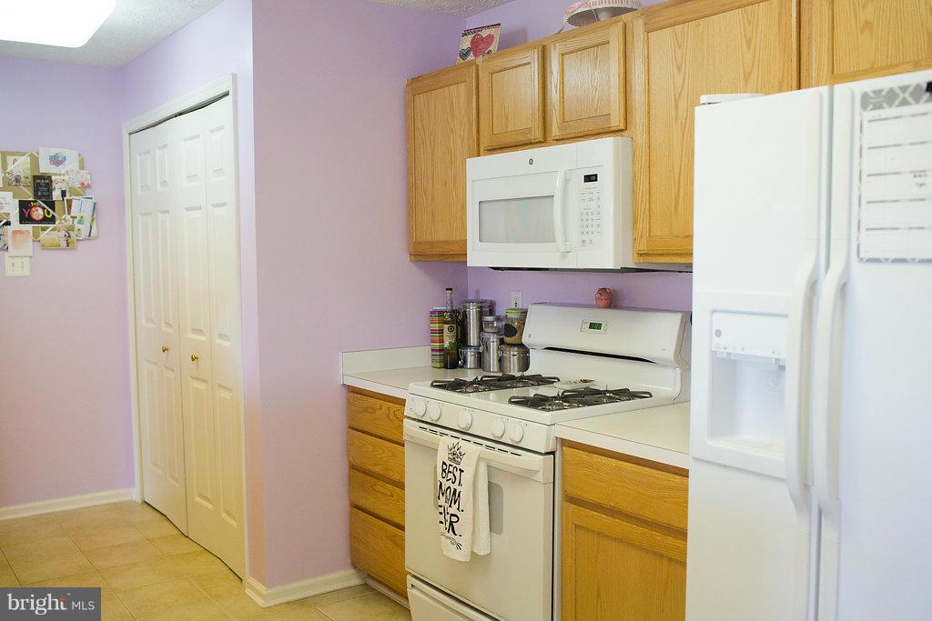 3018 Hunting Ridge Drive, Unit 3018 Owings Mills, MD 21117 - Photo 9 of 30 a kitchen with stainless steel appliances granite countertop a sink stove and refrigerator