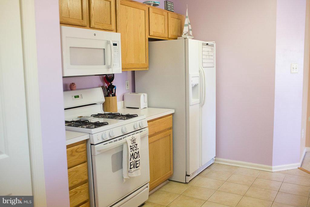 3018 Hunting Ridge Drive, Unit 3018 Owings Mills, MD 21117 - Photo 10 of 30 a kitchen with a stove and a refrigerator