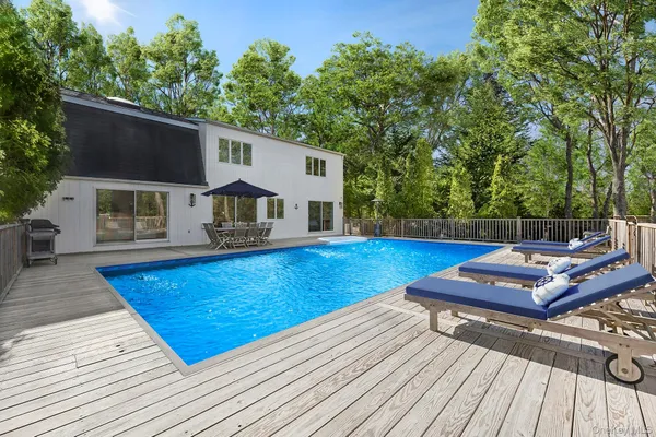 swimming pool view with a seating space