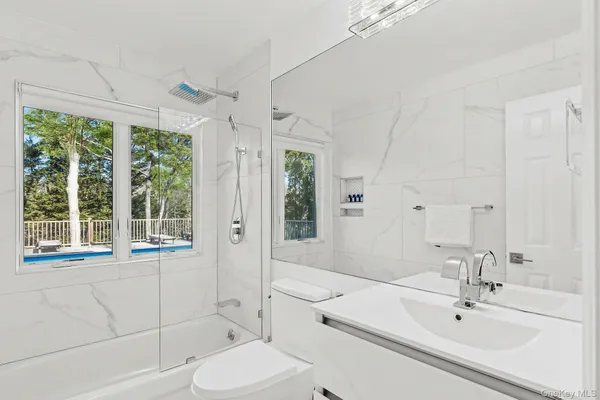 a bathroom with a sink toilet and shower