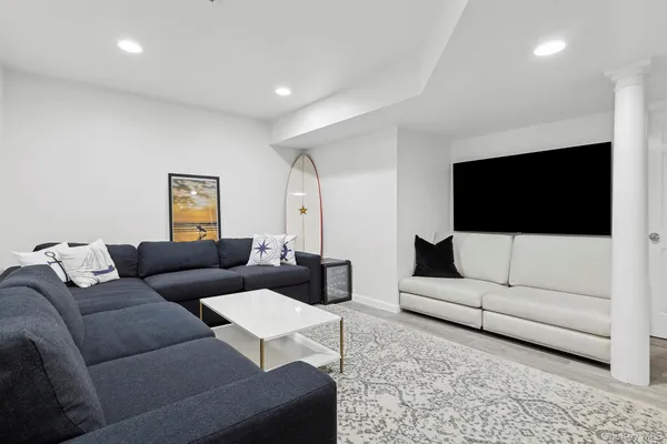 a living room with couches and a flat screen tv