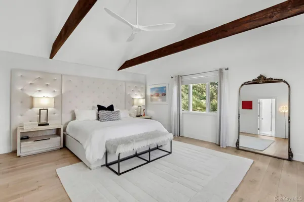 a bedroom with a large bed and a chandelier