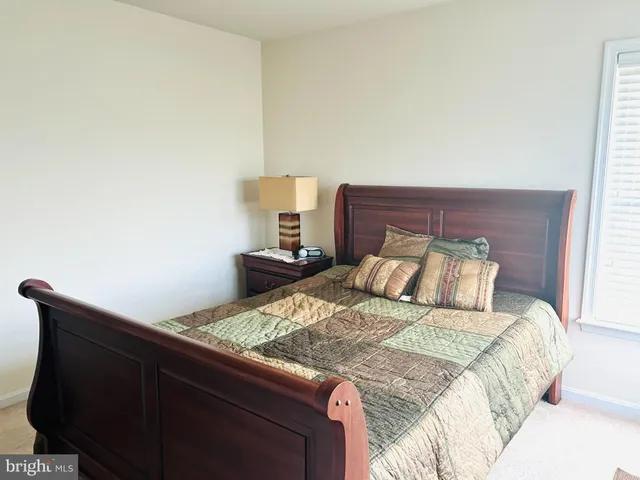 a bed sitting in a bedroom next to a lamp