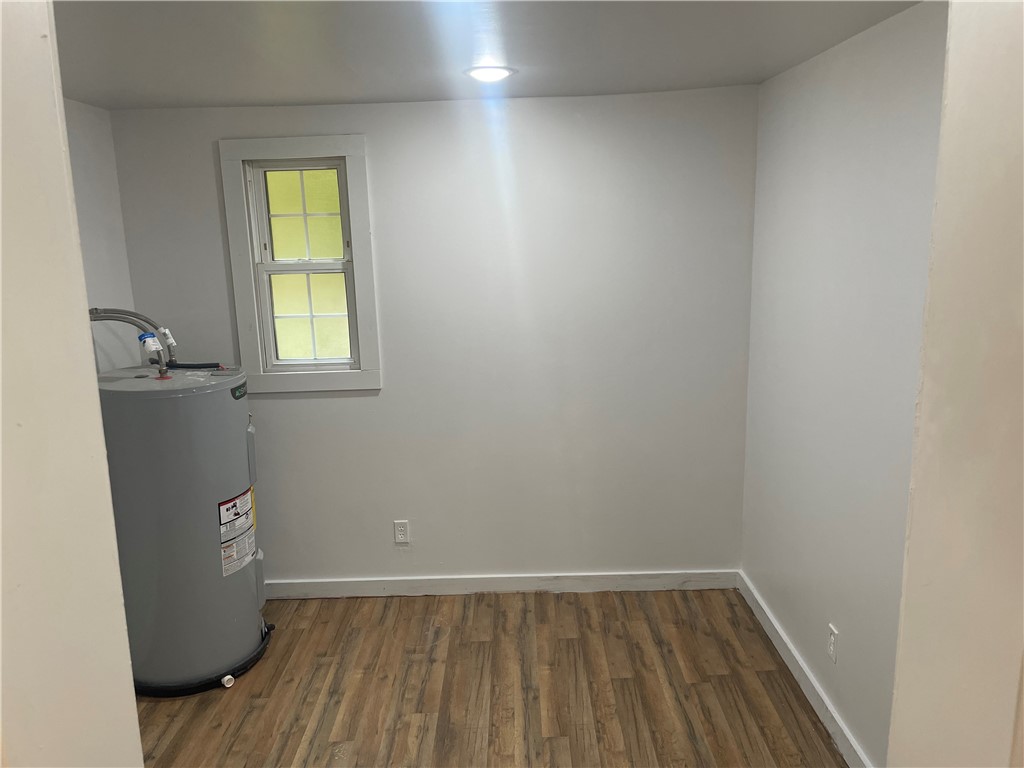 201 Craft Street Calhoun Falls, SC 29628 - Photo 5 of 12 This versatile utility room offers durable wood flooring and ample space for essential home functions.