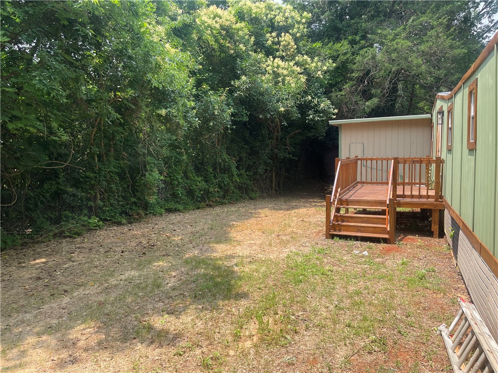 201 Craft Street Calhoun Falls, SC 29628 - Photo 10 of 12 This outdoor space offers a private retreat with lush greenery.