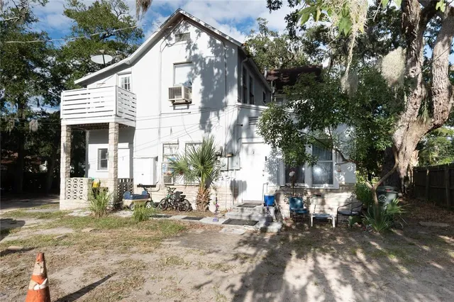 a view of a house with backyard and sitting area