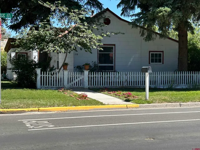 a view of front door of house with wooden fence