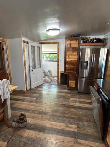 a view of a livingroom with furniture and staircase