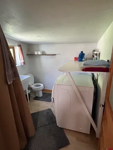 a living room with furniture and a painting on the wall