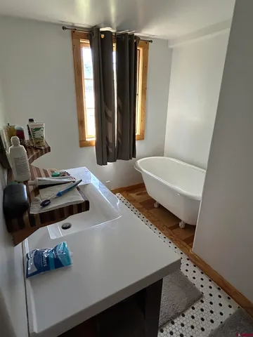 a living room with a bed furniture and a window