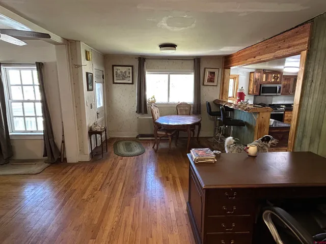 a view of a dining room with furniture and wooden floor