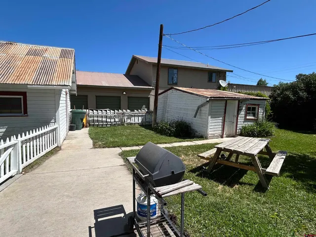 a view of backyard of house with outdoor seating