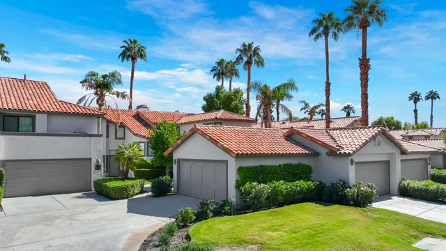 a view of a house with a backyard and a palm tree