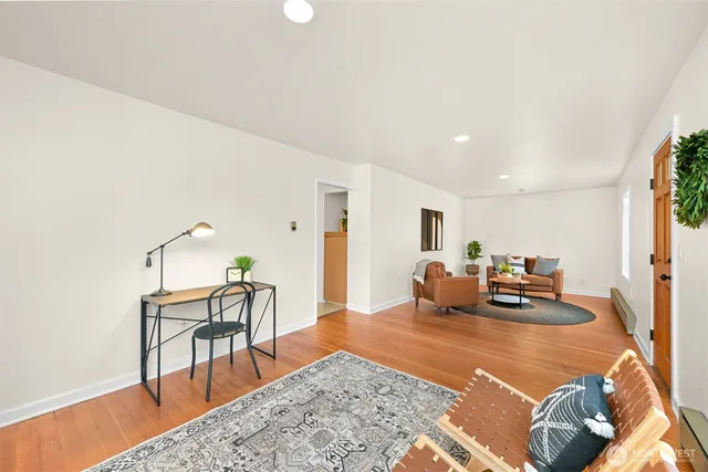 a bedroom with furniture and wooden floor