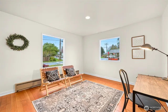 a bedroom with furniture and a rug