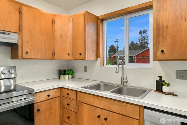 a kitchen with stainless steel appliances granite countertop a sink and cabinets