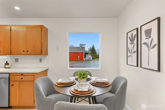 a dining room with furniture and window