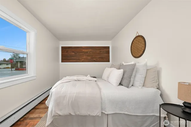 a bedroom with a bed and a window